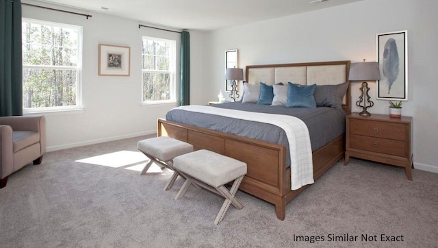 bedroom with light carpet, visible vents, and baseboards