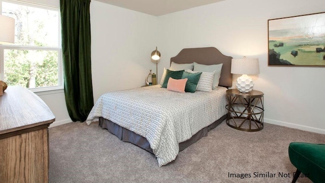 carpeted bedroom with baseboards