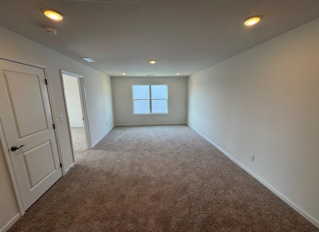 carpeted empty room with baseboards