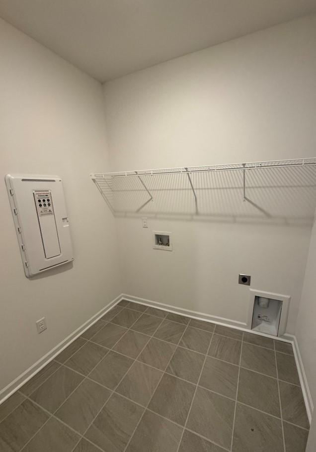 washroom featuring laundry area, hookup for a washing machine, baseboards, and electric dryer hookup