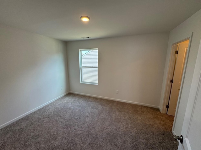 spare room featuring visible vents, baseboards, and carpet floors