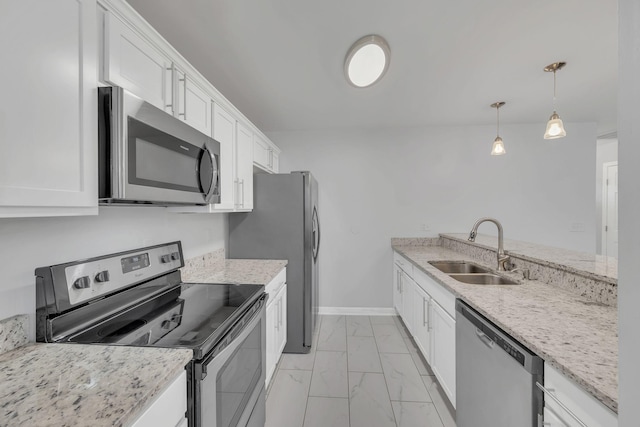 kitchen featuring marble finish floor, a sink, white cabinetry, appliances with stainless steel finishes, and baseboards