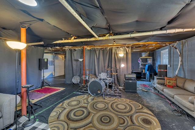 unfinished basement featuring electric panel and concrete block wall