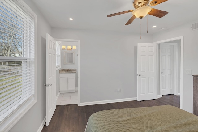 unfurnished bedroom featuring recessed lighting, connected bathroom, baseboards, and wood finished floors