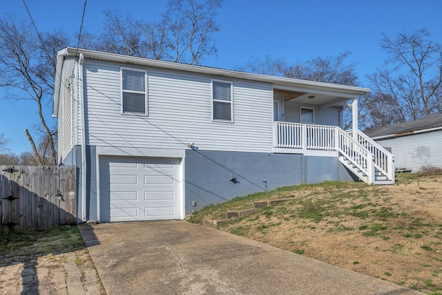 ranch-style house with fence, an attached garage, covered porch, stairs, and concrete driveway