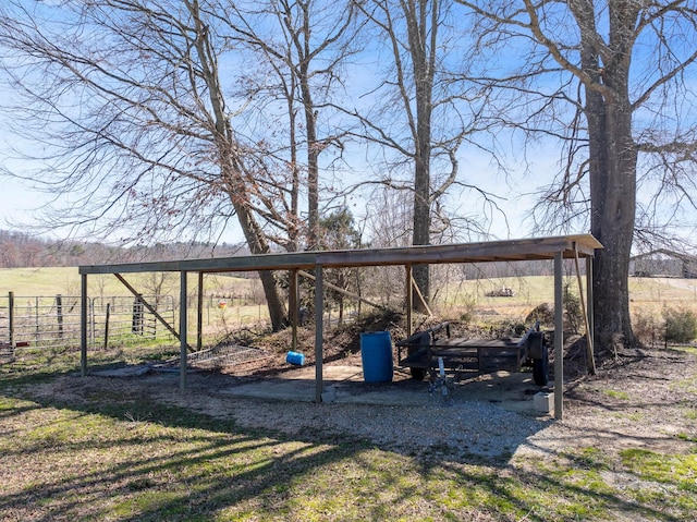 view of yard featuring a rural view and fence