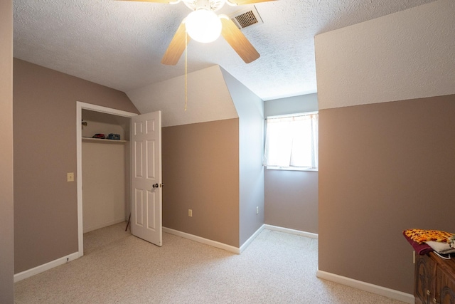 additional living space with visible vents, baseboards, carpet, vaulted ceiling, and a ceiling fan