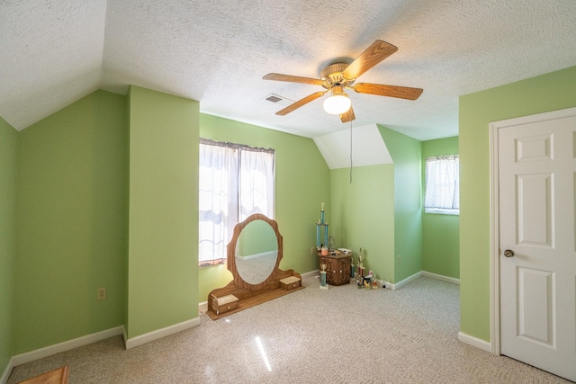 playroom with a wealth of natural light, visible vents, carpet flooring, and vaulted ceiling