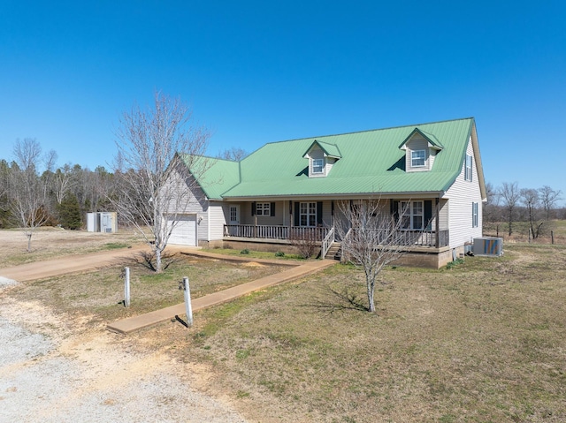 view of front of property with central AC unit, covered porch, metal roof, and dirt driveway