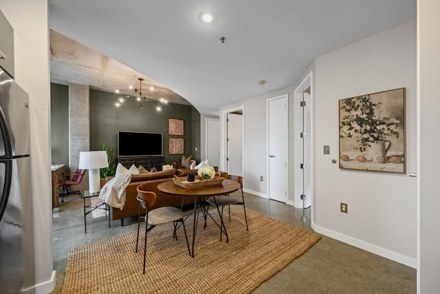 dining area with an inviting chandelier and baseboards