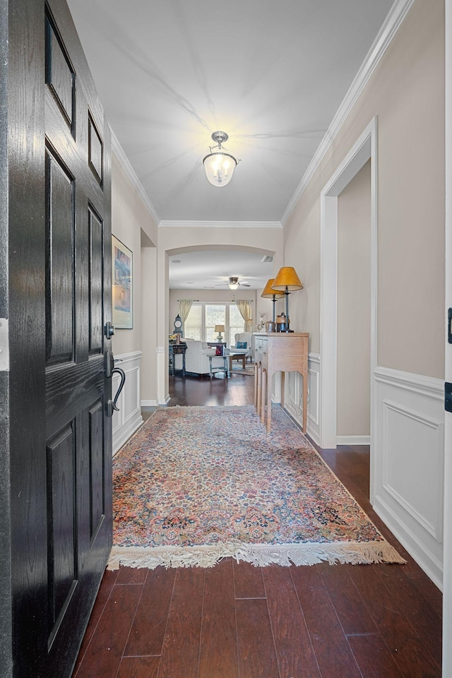 entrance foyer featuring hardwood / wood-style floors, crown molding, and wainscoting