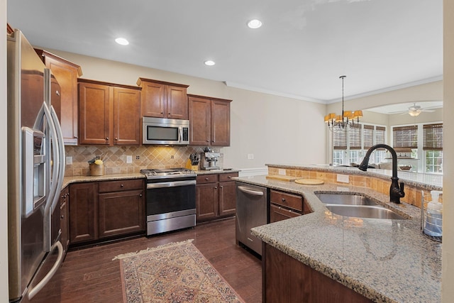 kitchen featuring a sink, decorative backsplash, dark wood-style floors, and stainless steel appliances