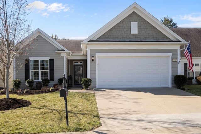 ranch-style home featuring a front lawn, a garage, and driveway