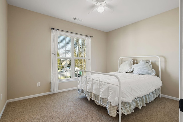 bedroom with baseboards, carpet floors, visible vents, and ceiling fan