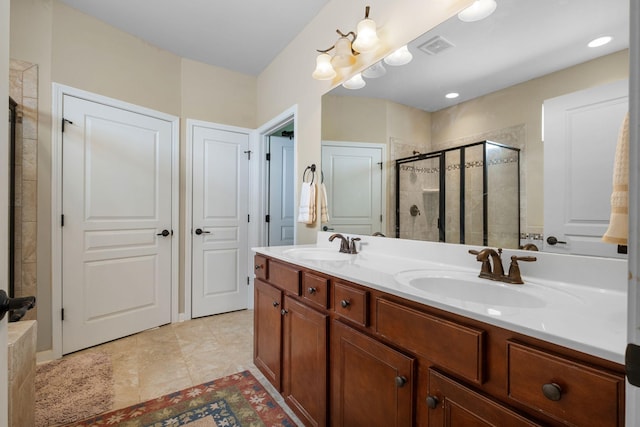 bathroom featuring a sink, visible vents, double vanity, and a shower stall