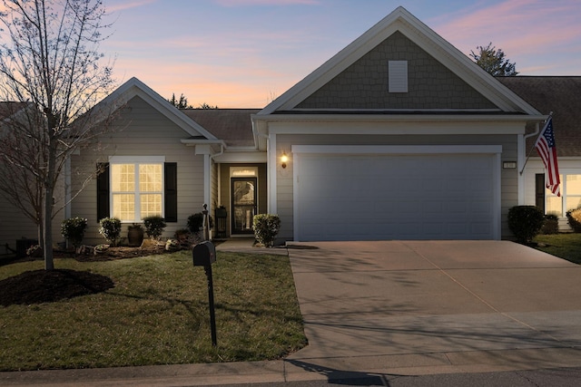 view of front of house featuring a garage, a lawn, and concrete driveway