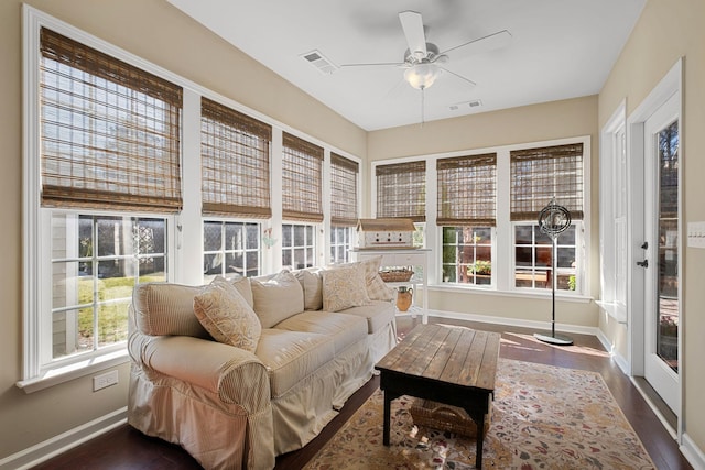 sunroom with a healthy amount of sunlight, visible vents, and ceiling fan