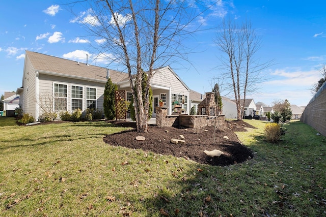 rear view of house featuring a lawn