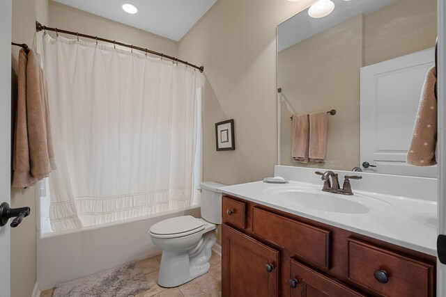 bathroom with tile patterned flooring, shower / tub combo with curtain, toilet, and vanity