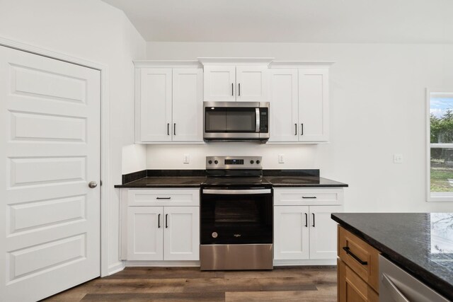 kitchen featuring white cabinetry, dark wood-style floors, and stainless steel appliances