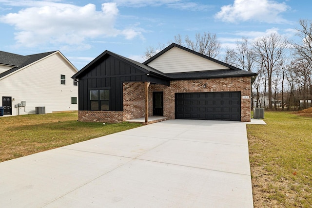 view of front of property featuring a front yard, central AC unit, an attached garage, board and batten siding, and brick siding