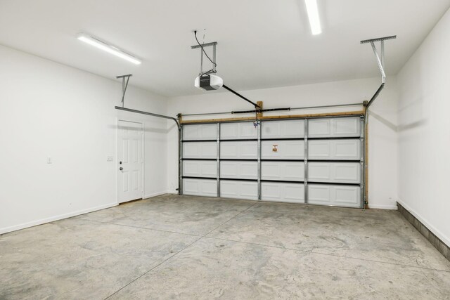 garage featuring baseboards and a garage door opener