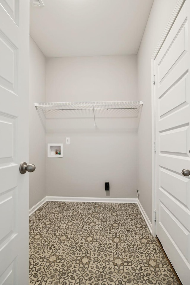 washroom featuring laundry area, hookup for a washing machine, and baseboards