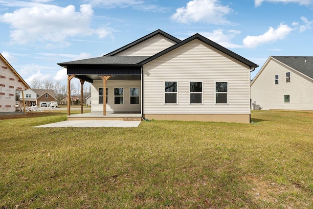 back of house with a patio and a yard