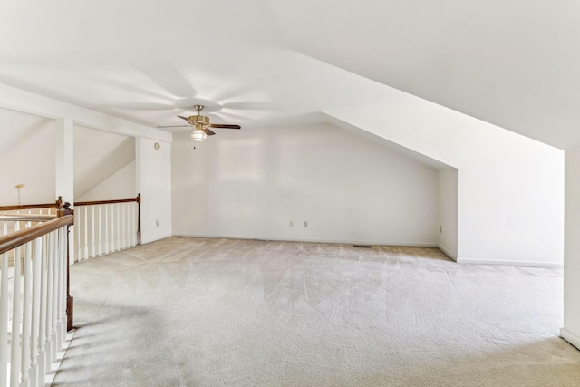 bonus room with light carpet, ceiling fan, and vaulted ceiling