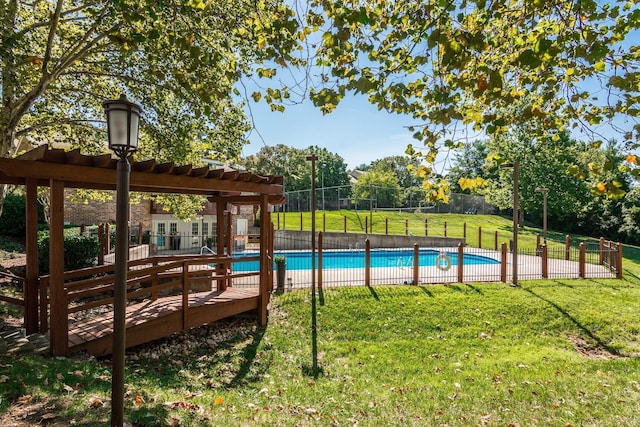 view of pool with a lawn, a pergola, fence, and a fenced in pool