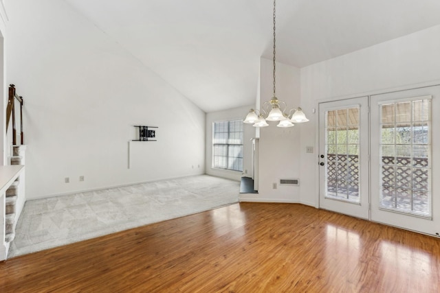 interior space featuring stairway, high vaulted ceiling, wood finished floors, and a chandelier