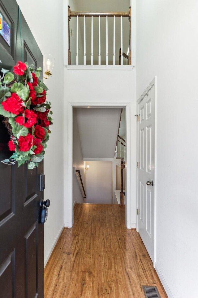 entrance foyer with baseboards, visible vents, and light wood finished floors