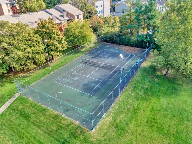 view of sport court featuring a yard and fence