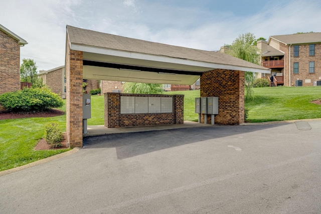 surrounding community featuring a lawn and mail area