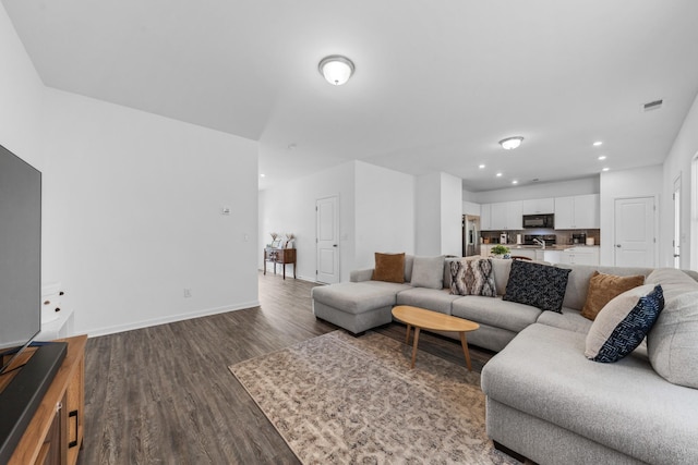 living room featuring dark wood-type flooring, recessed lighting, baseboards, and visible vents