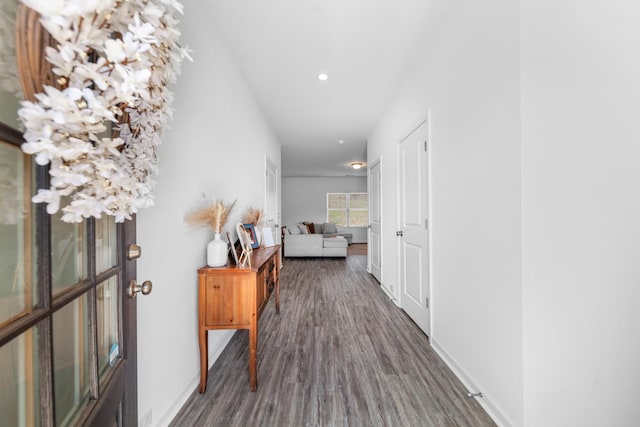 hallway featuring recessed lighting, baseboards, and dark wood finished floors