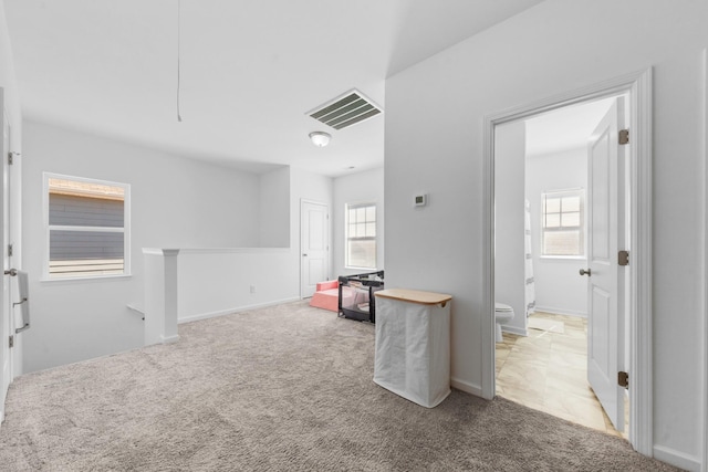 empty room with visible vents, carpet floors, and a healthy amount of sunlight