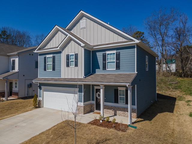 818 Lottie St, Columbia, TN 38401 - view of front of home with an attached garage, covered porch, concrete driveway, board and batten siding, and brick siding