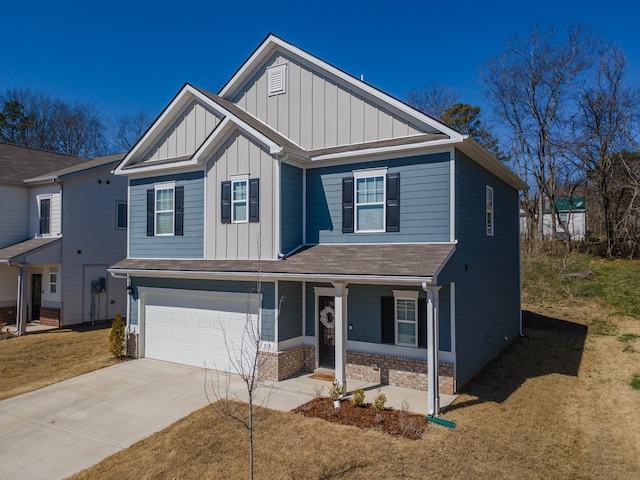 view of front of home with an attached garage, covered porch, concrete driveway, board and batten siding, and brick siding