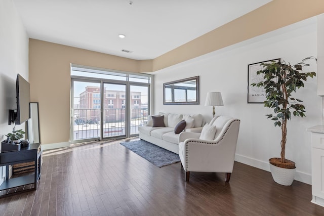 living room featuring visible vents, baseboards, and dark wood-type flooring