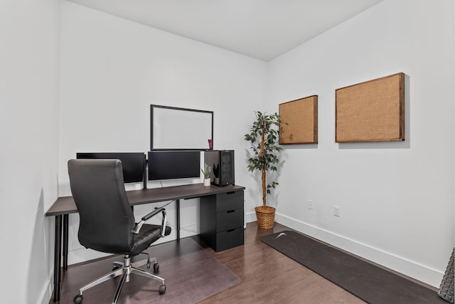 home office featuring baseboards and wood finished floors