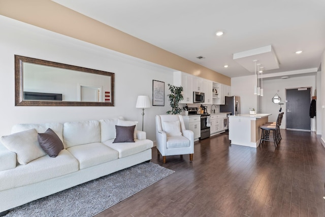 living room featuring recessed lighting and dark wood-style flooring