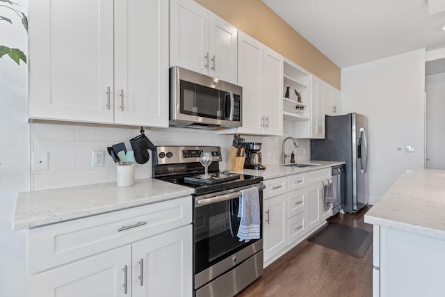 kitchen featuring tasteful backsplash, a sink, dark wood finished floors, stainless steel appliances, and open shelves