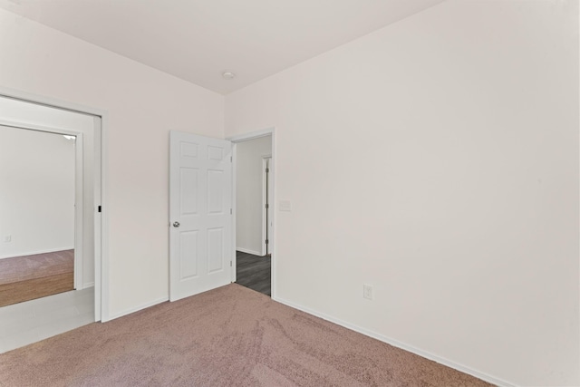 unfurnished bedroom featuring baseboards and carpet flooring