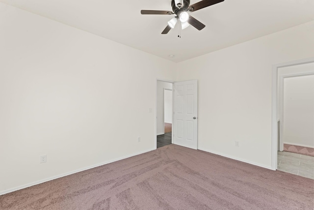 unfurnished room featuring baseboards, carpet, and ceiling fan