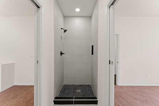 full bathroom with baseboards and tiled shower