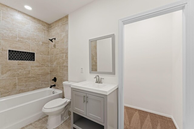 full bathroom featuring tile patterned flooring, vanity,  shower combination, and toilet