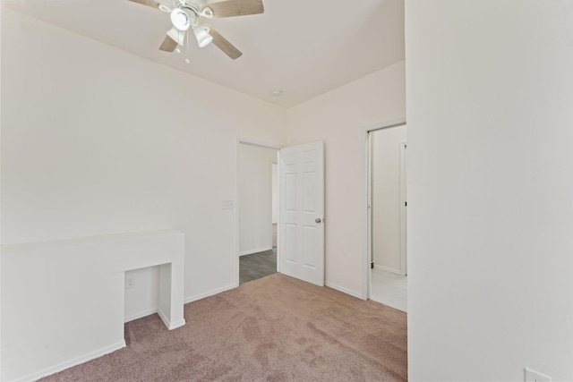 spare room featuring a ceiling fan, baseboards, and carpet floors