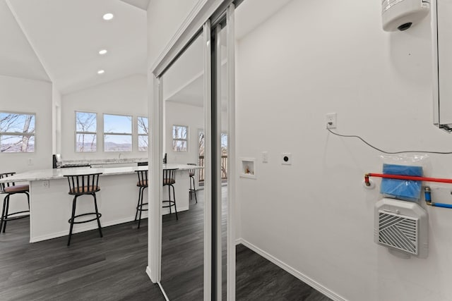 interior space featuring washer hookup, dark wood-style floors, recessed lighting, baseboards, and hookup for an electric dryer