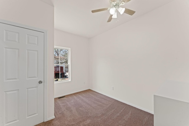 empty room featuring visible vents, baseboards, carpet, and ceiling fan